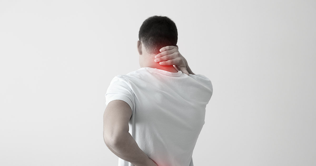 Man viewed from behind pressing his right hand to the back of his neck and his left hand to his lower back, with a red-highlighted area showing pain at the neck and spine