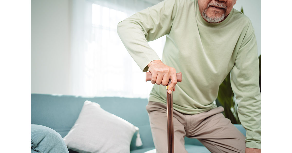 Person resting on a park bench to relieve leg pain after walking