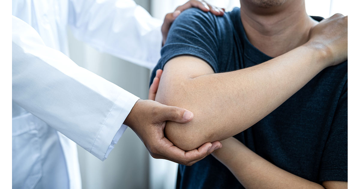 Clinician examining a patient's shoulder during a conservative care evaluation for labrum injury